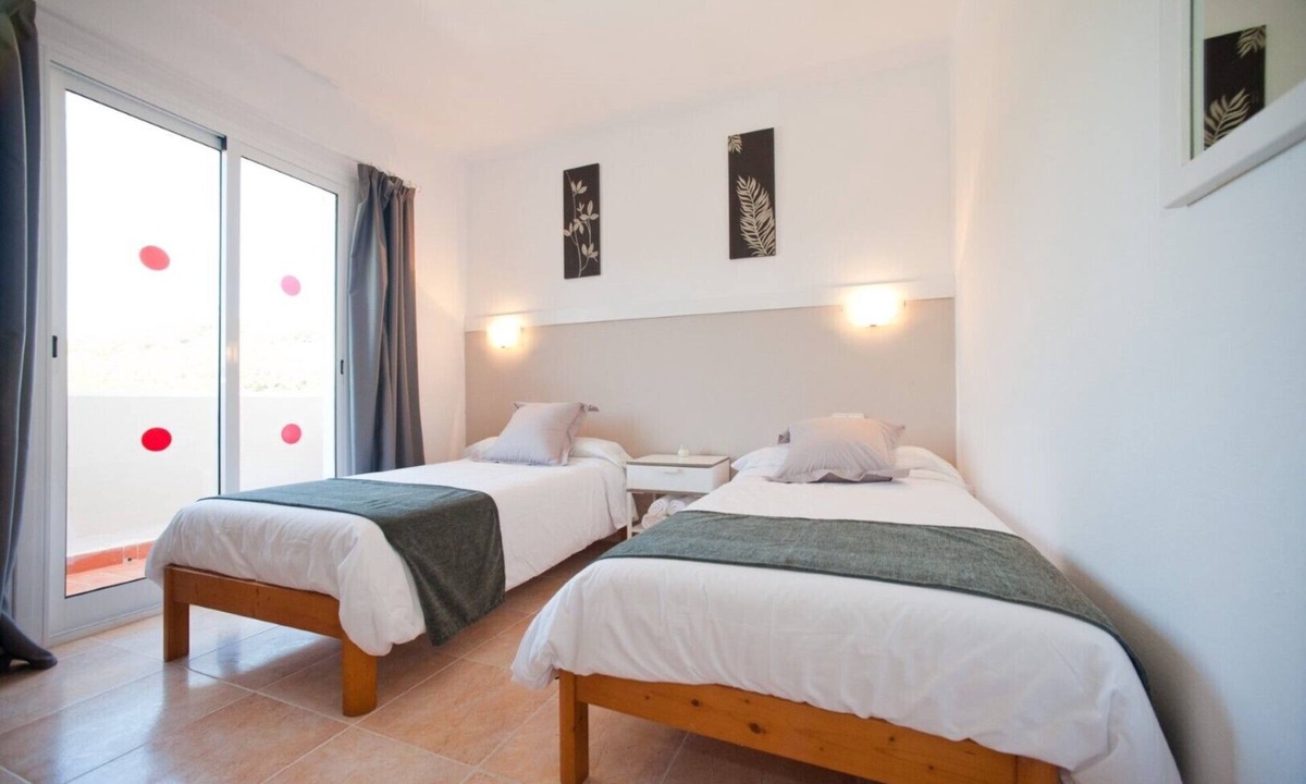 Santa Eulalia del Rio Apartment | Apartment Ses Veles 2 dormitorios close to the Beach with Sea View, Pool, Wi-Fi & Garden