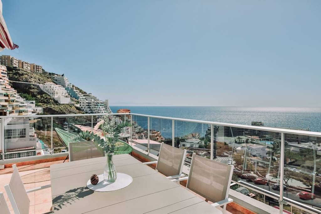 Tabaiba Apartment | Sit back on the terrace and enjoy incredible views of mountains and the ocean beyond. Flooded with natural light, the interior is beautifully curated in a rich beachside palette of pastel hues with nautical touches.