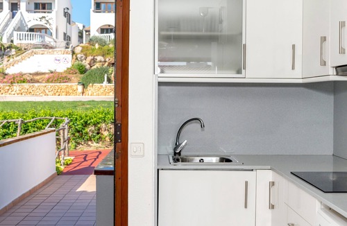 Arenal d'en Castell Apartment | Apartment 'Arenal De'n Castell' with Sea View, Shared Pool and Wi-Fi